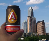 Austin Beer Works Can Held up in the Austin Skyline